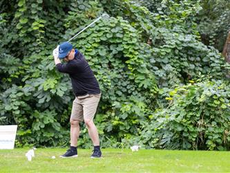 golf player swinging club