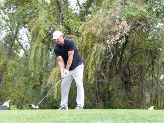 golf attendee teeing off