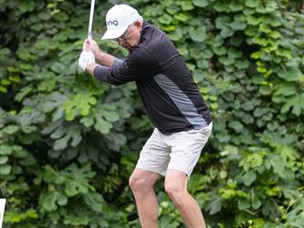 golf player swinging club