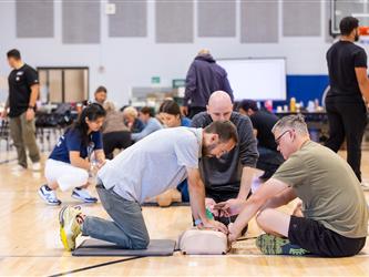 Attendee learning how to perform CPR