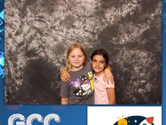 two girls posing for photo booth 