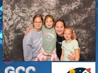 family posing for photobooth