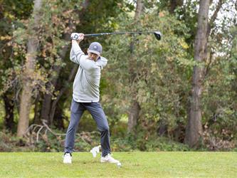 golf player swinging club