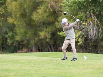 golf player swinging club