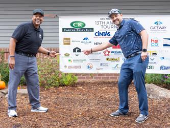 golf attendees posing at sign