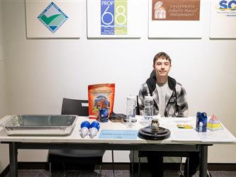 student posed at table