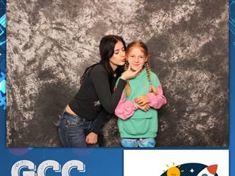 mom kissing daughter on cheek 