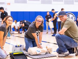 Attendees learning how to perform CPR