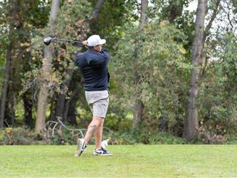 golf player swinging club