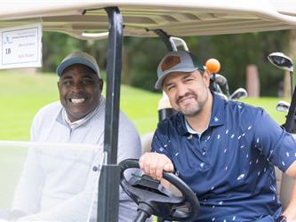 players driving golf cart