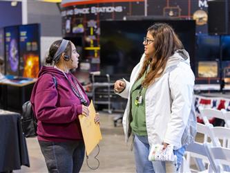 career fair attendees interacting with another