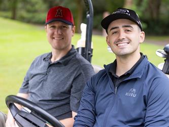 players driving golf cart