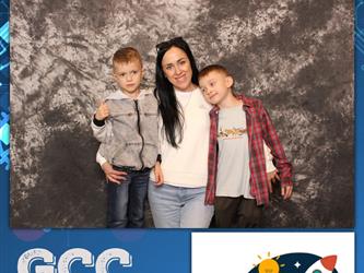 family posing for photobooth
