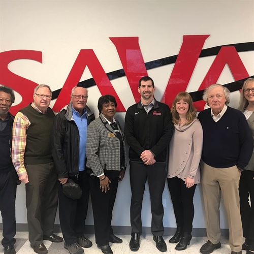 GCC Board of DIrectors standing in front of SAVA sign