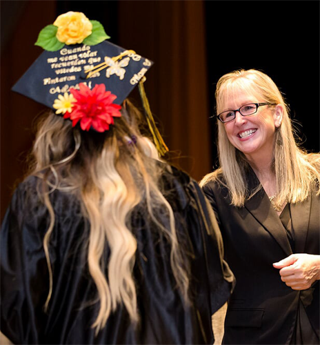 Student shaking hands with GCC Superintendent after graduating
