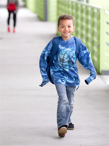 Student smiling walking in hallway